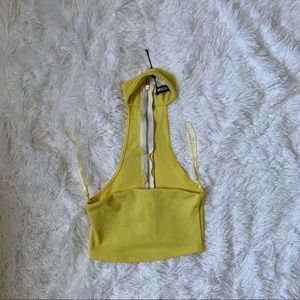 Yellow tube top. Zipper on the back. Choker.